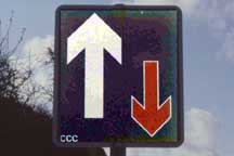 Sign: Red arrow, white arrow
